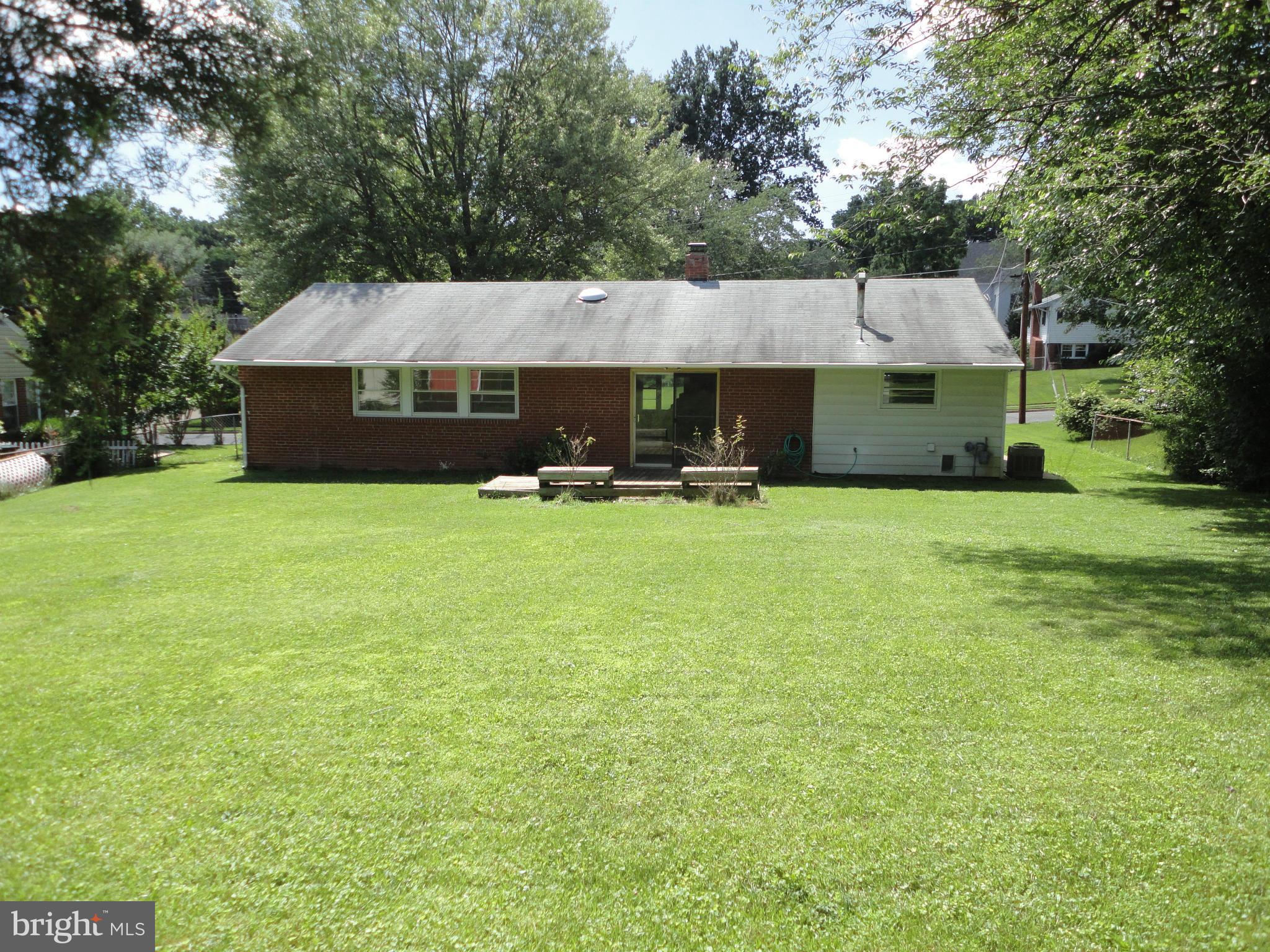 5512 Moultrie Road Springfield, VA 22151 - Photo 7 of 27 a front view of house with yard and trees in the background