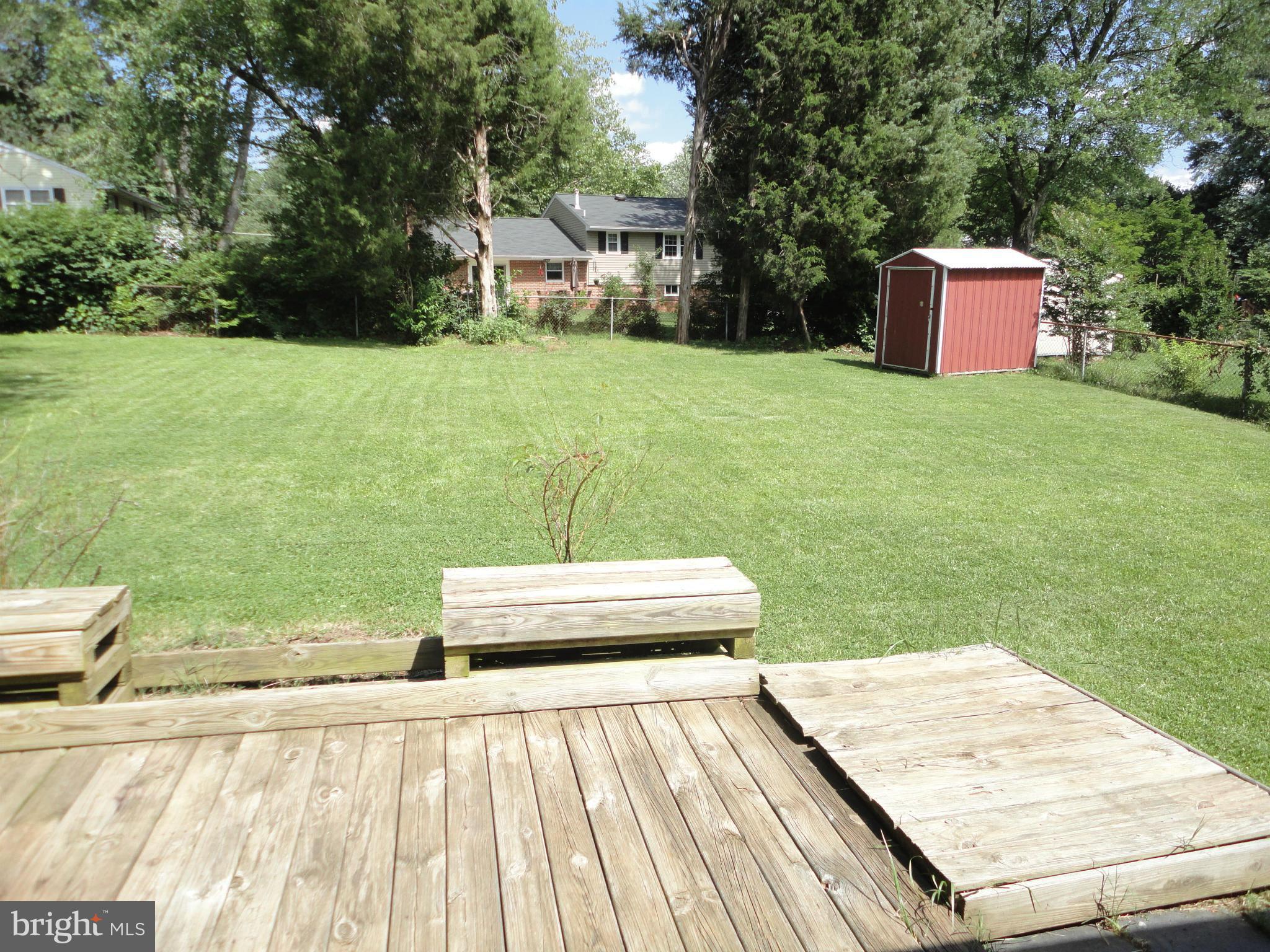 5512 Moultrie Road Springfield, VA 22151 - Photo 10 of 27 a backyard of a house with wooden floor and fence