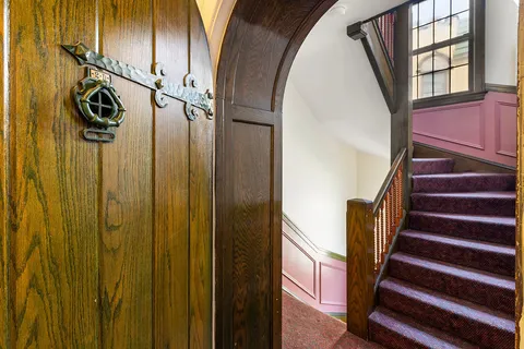 a view of an entryway with wooden floor and door
