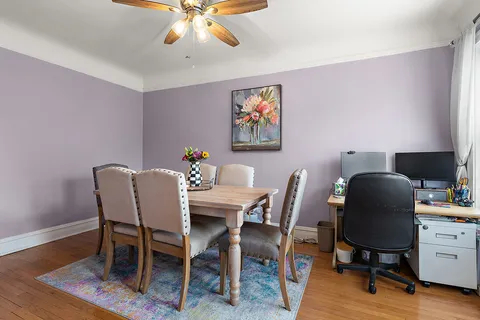 a dining room with furniture and wooden floor