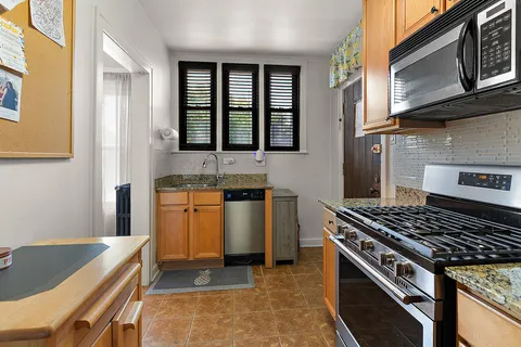 a kitchen with stove and cabinets