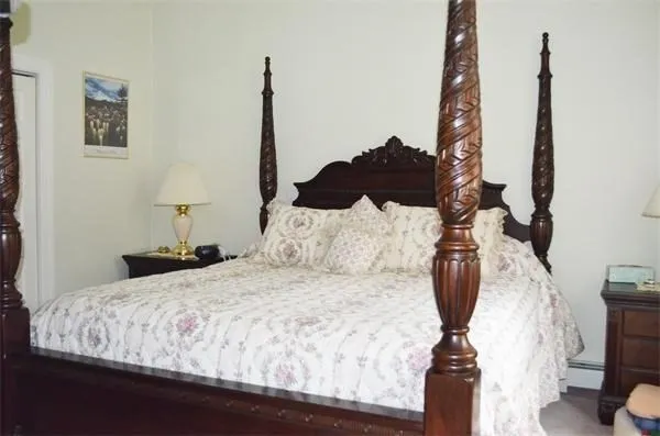 a bed sitting in a bedroom and chair