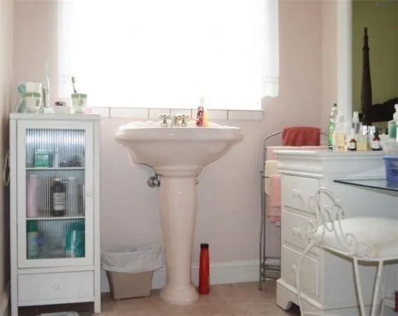 a bathroom with a sink a toilet and mirror