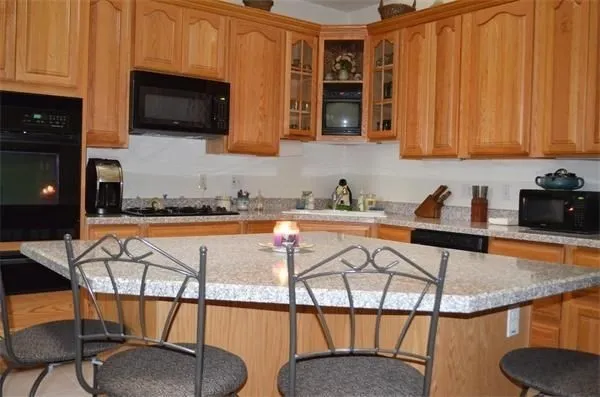 a view of a kitchen with furniture and flat screen tv