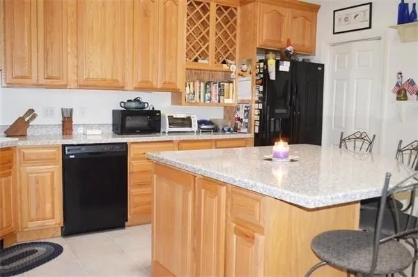 a kitchen with stainless steel appliances kitchen island granite countertop a sink and cabinets