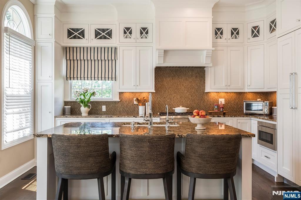 114 Harrison Avenue Montclair, NJ 07042 - Photo 12 of 41 a kitchen with granite countertop white cabinets and stainless steel appliances