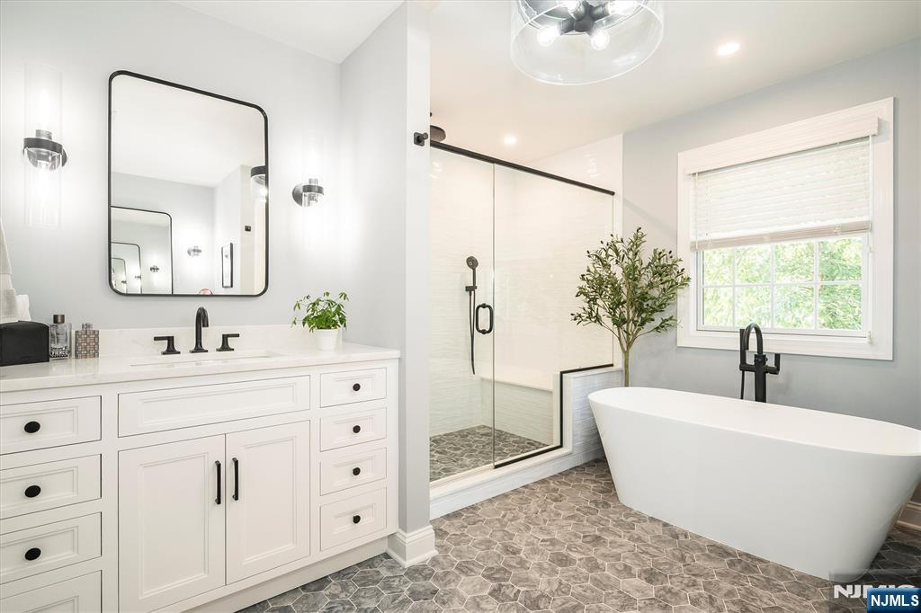 114 Harrison Avenue Montclair, NJ 07042 - Photo 26 of 41 a spacious bathroom with a double vanity sink a mirror a and a window