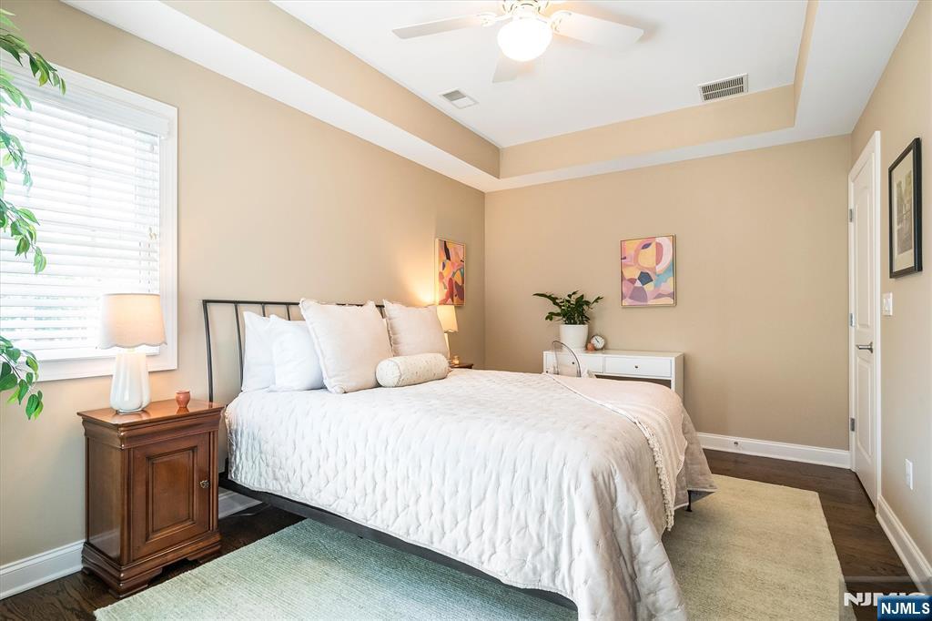 114 Harrison Avenue Montclair, NJ 07042 - Photo 30 of 41 a bedroom with a bed and a chandelier