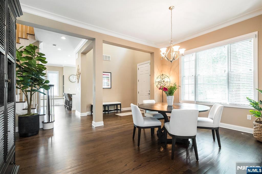114 Harrison Avenue Montclair, NJ 07042 - Photo 8 of 41 a dining room with wooden floor a chandelier a glass table and chairs