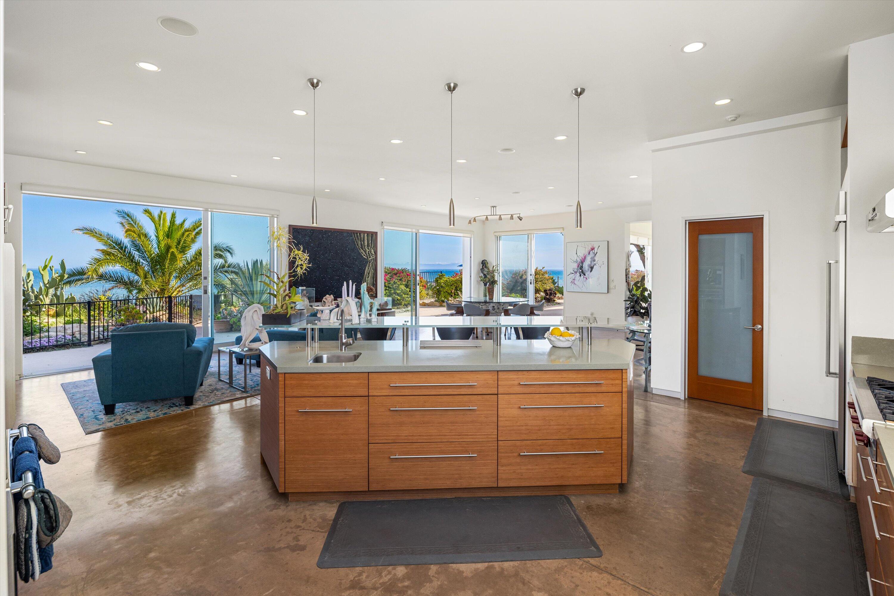 5297 Austin Road Santa Barbara, CA 93111 - Photo 12 of 35 a dining hall with stainless steel appliances kitchen island granite countertop a table and chairs in it