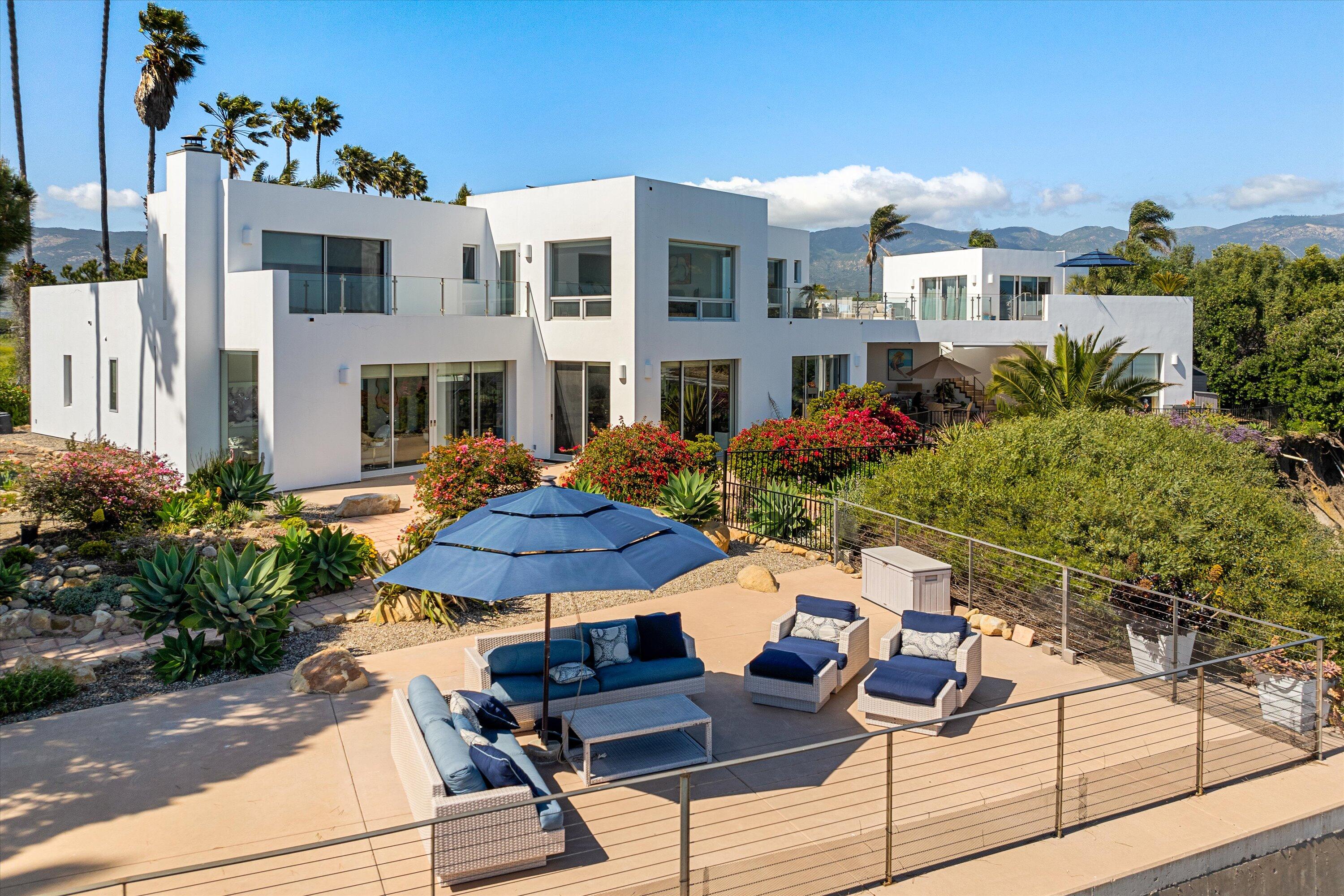 5297 Austin Road Santa Barbara, CA 93111 - Photo 2 of 35 a view of a patio with table and chairs potted plants and large tree