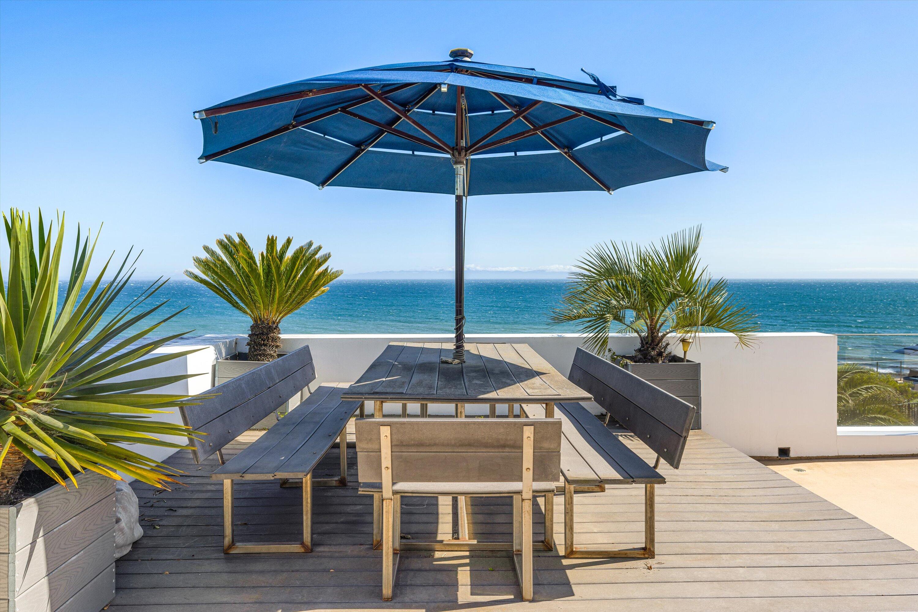 5297 Austin Road Santa Barbara, CA 93111 - Photo 21 of 35 a terrace with a table and chairs under an umbrella