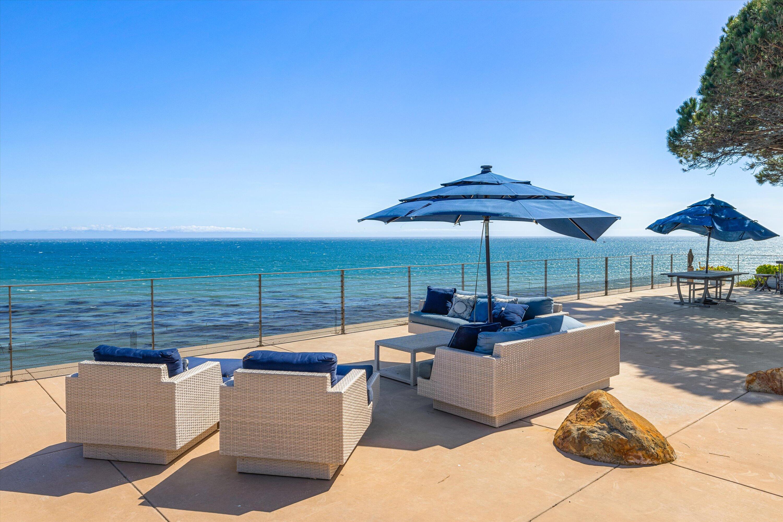 5297 Austin Road Santa Barbara, CA 93111 - Photo 28 of 35 a view of a patio with couches under an umbrella