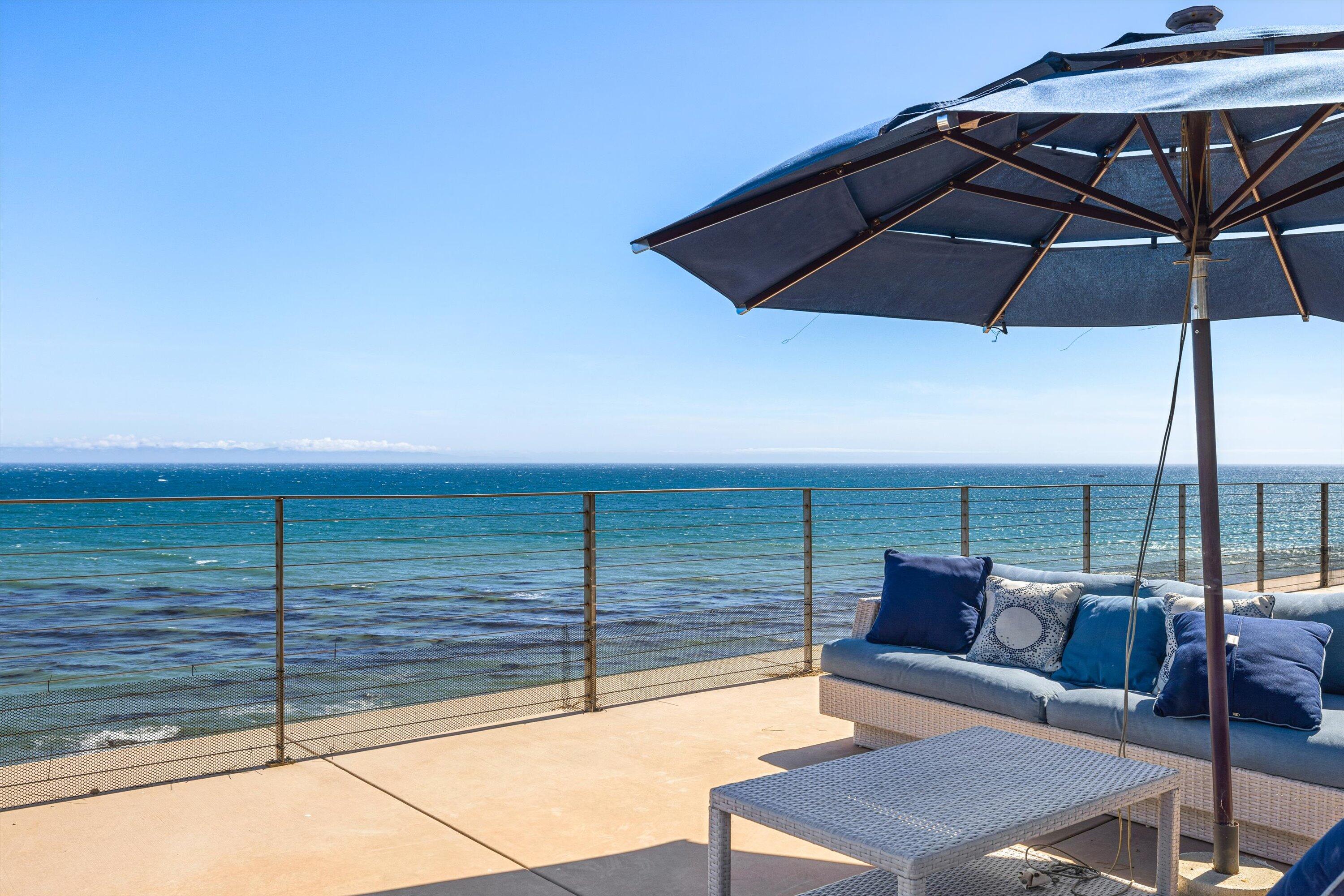 5297 Austin Road Santa Barbara, CA 93111 - Photo 29 of 35 a view of a terrace with couches and an umbrella