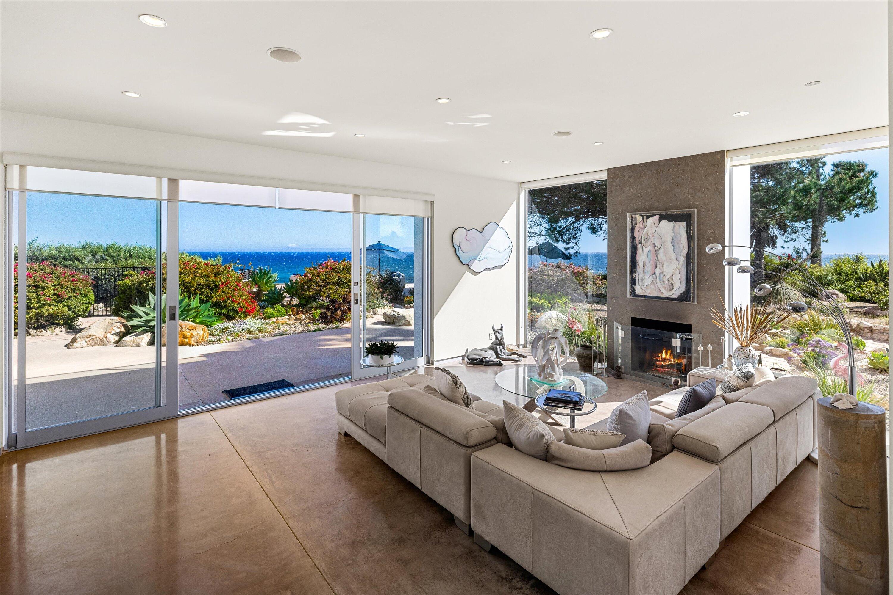 5297 Austin Road Santa Barbara, CA 93111 - Photo 5 of 35 a living room with fireplace furniture and a large window