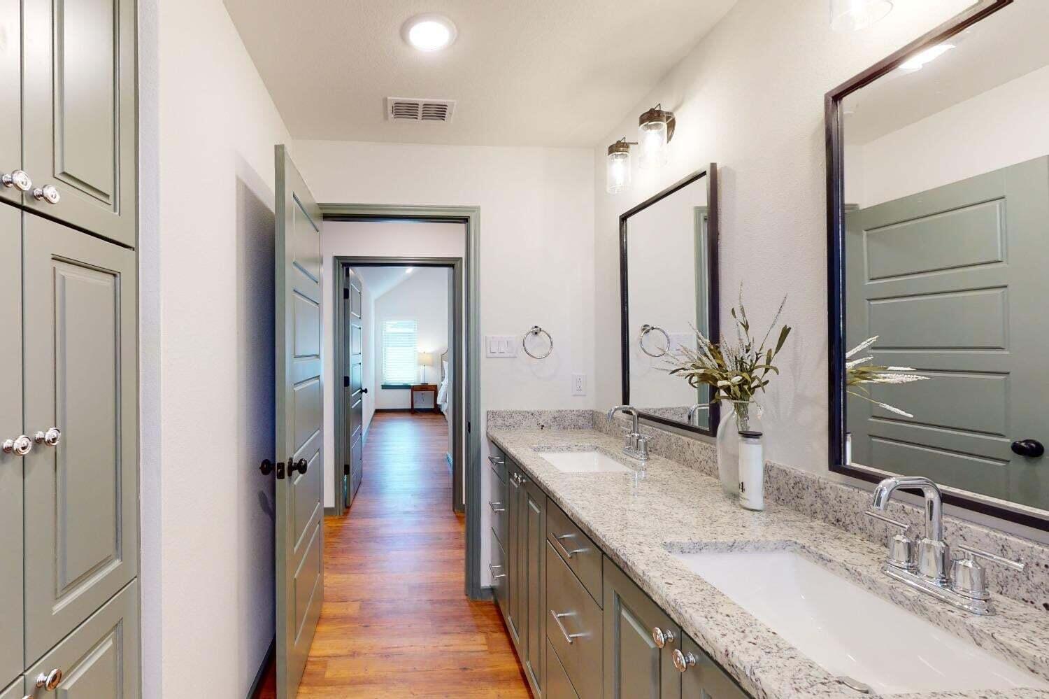 3617 128th Street Lubbock, TX 79423 - Photo 23 of 30 a bathroom with a granite countertop double vanity sink and a mirror