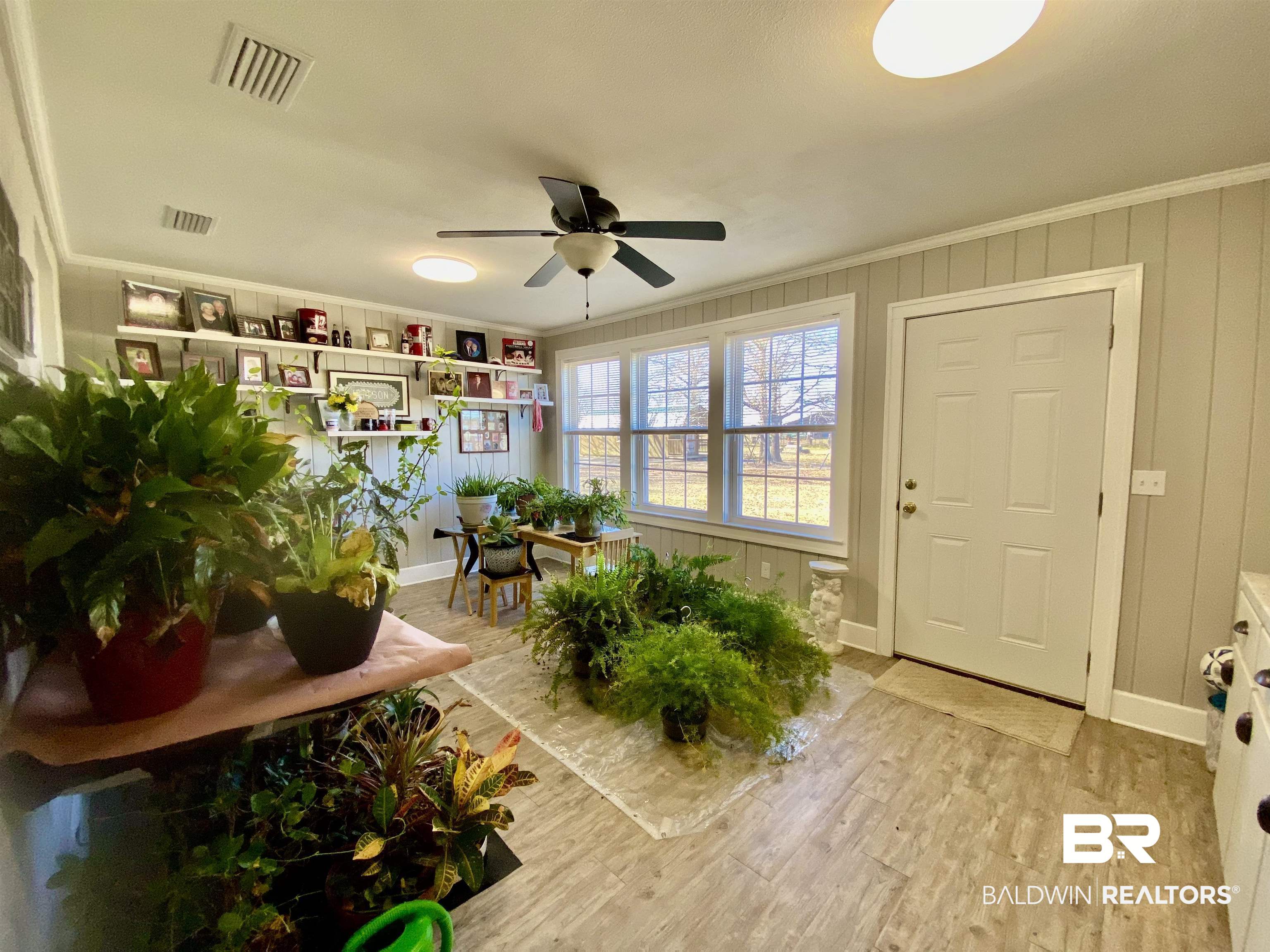2711 County Road 5 Repton, AL 36475 - Photo 29 of 36 Back entrance/ Sunroom with ceiling fan, crown molding, and light hardwood / wood-style floors