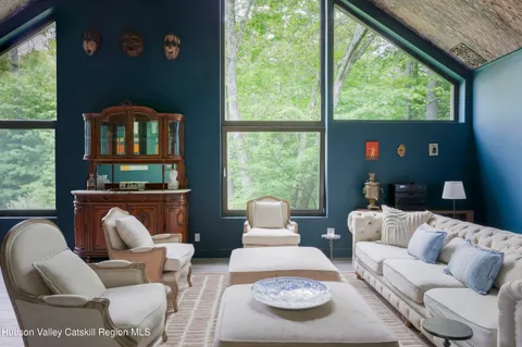 a living room with furniture and a floor to ceiling window
