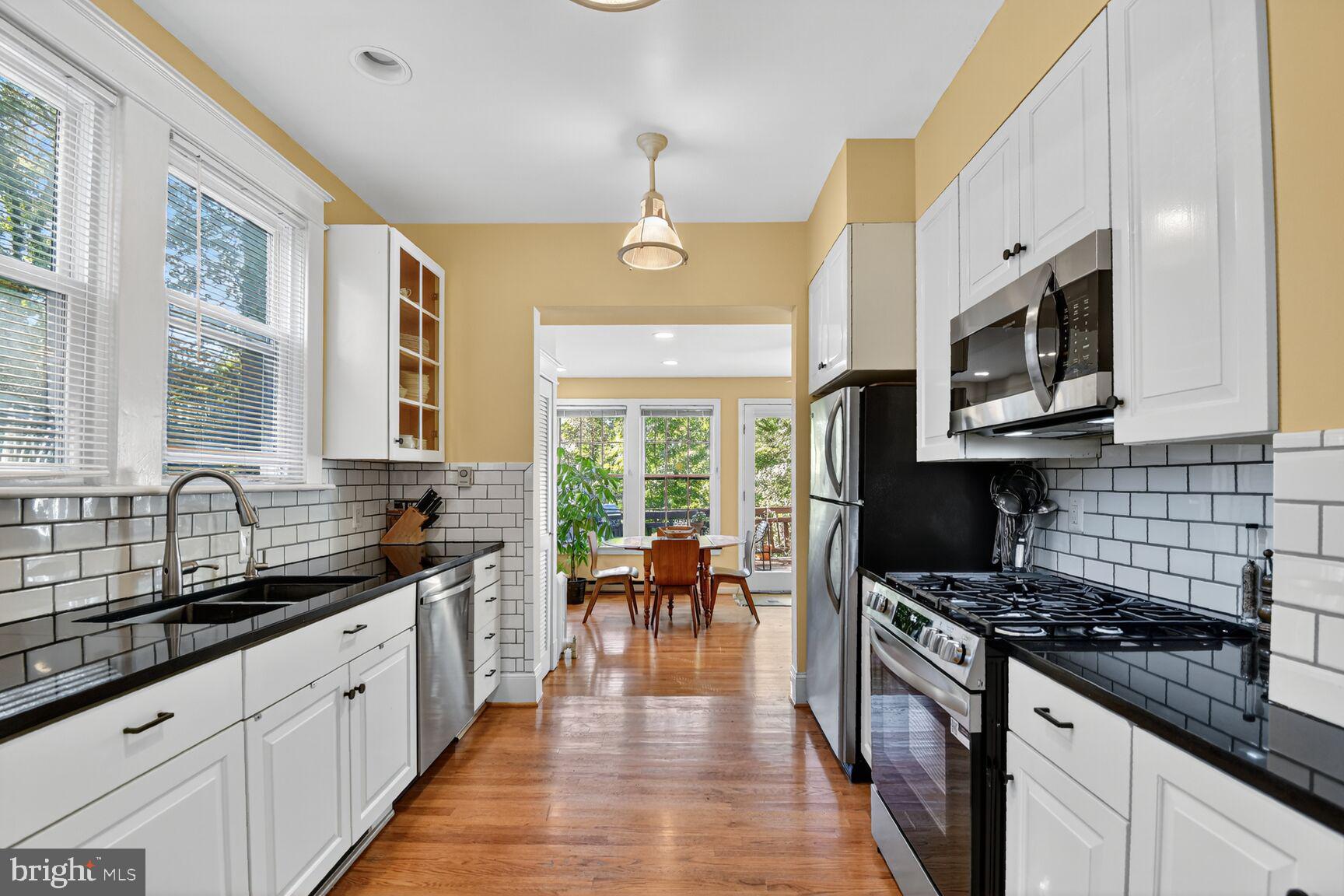 14 Cleveland Avenue Takoma Park, MD 20912 - Photo 12 of 41 a kitchen with stainless steel appliances granite countertop a stove a sink and a microwave