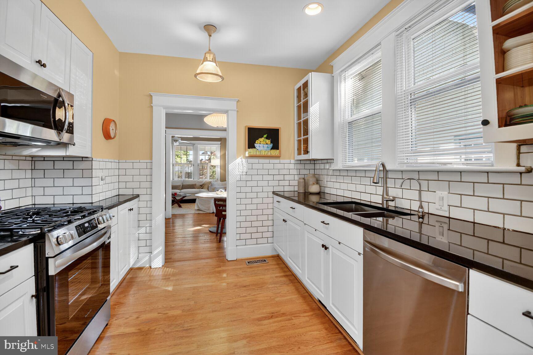 14 Cleveland Avenue Takoma Park, MD 20912 - Photo 13 of 41 a large kitchen with stainless steel appliances granite countertop a stove sink and cabinets