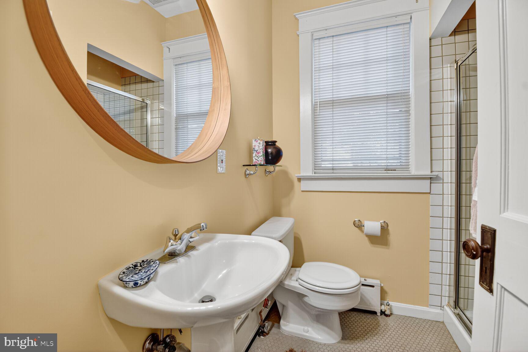 14 Cleveland Avenue Takoma Park, MD 20912 - Photo 23 of 41 a bathroom with a sink and mirror with toilet