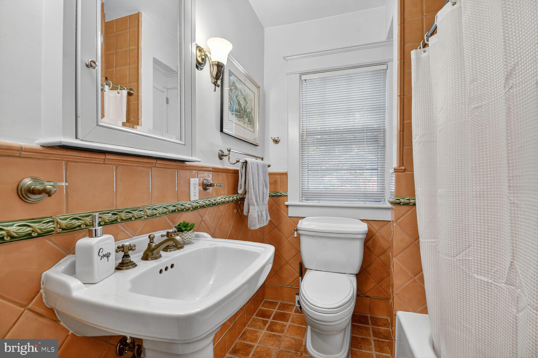 14 Cleveland Avenue Takoma Park, MD 20912 - Photo 28 of 41 a bathroom with a sink a toilet and shower