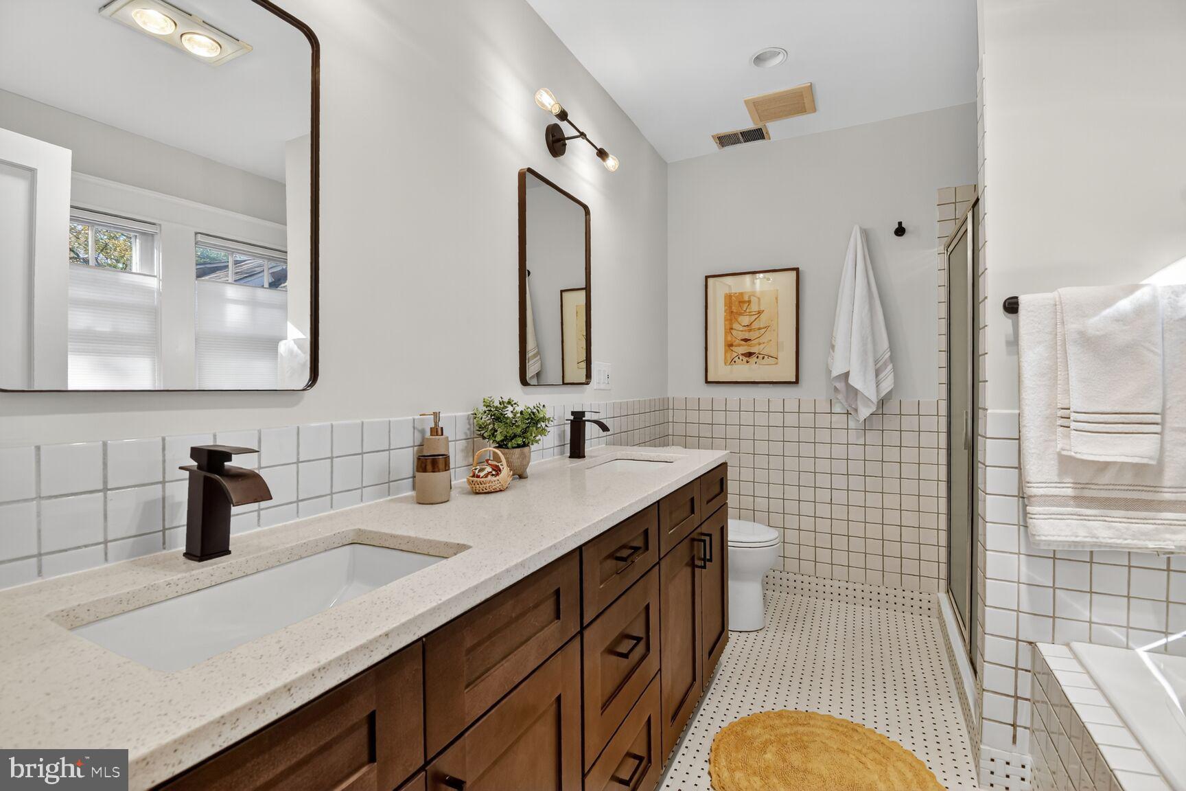 14 Cleveland Avenue Takoma Park, MD 20912 - Photo 34 of 41 a bathroom with a sink double vanity and a mirror