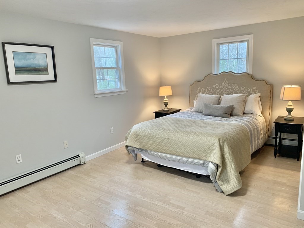 76 Old Douglas Road Webster, MA 01570 - Photo 11 of 22 a bedroom with a bed and a lamp on dresser