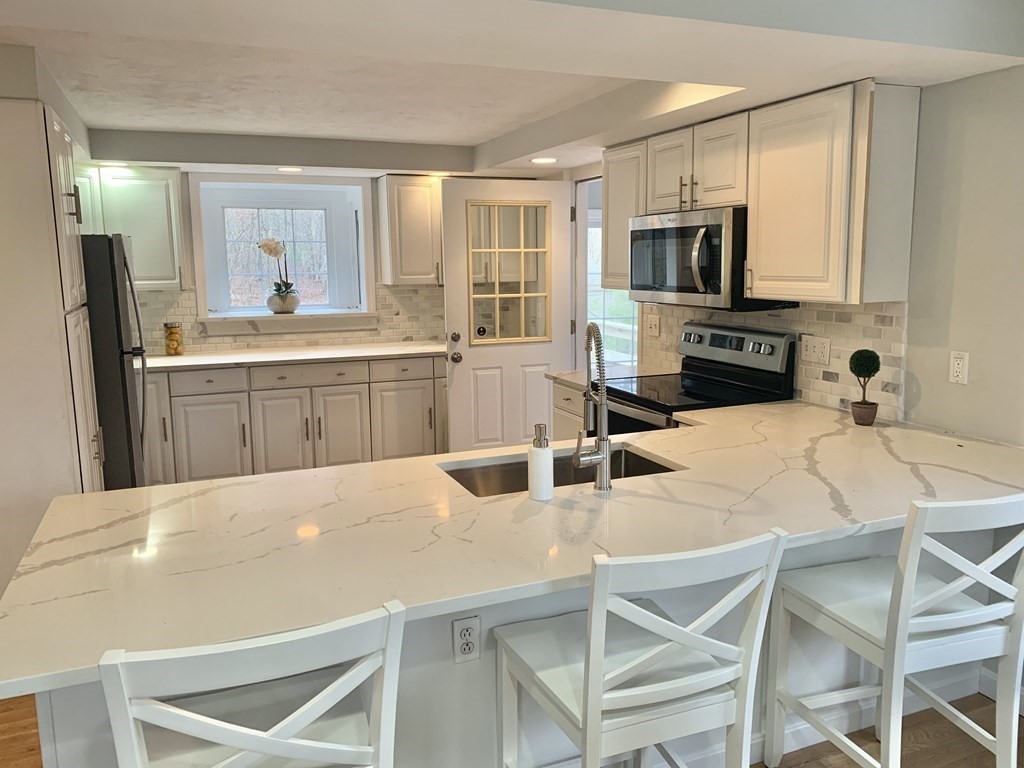 76 Old Douglas Road Webster, MA 01570 - Photo 4 of 22 a kitchen with stainless steel appliances a sink and a refrigerator