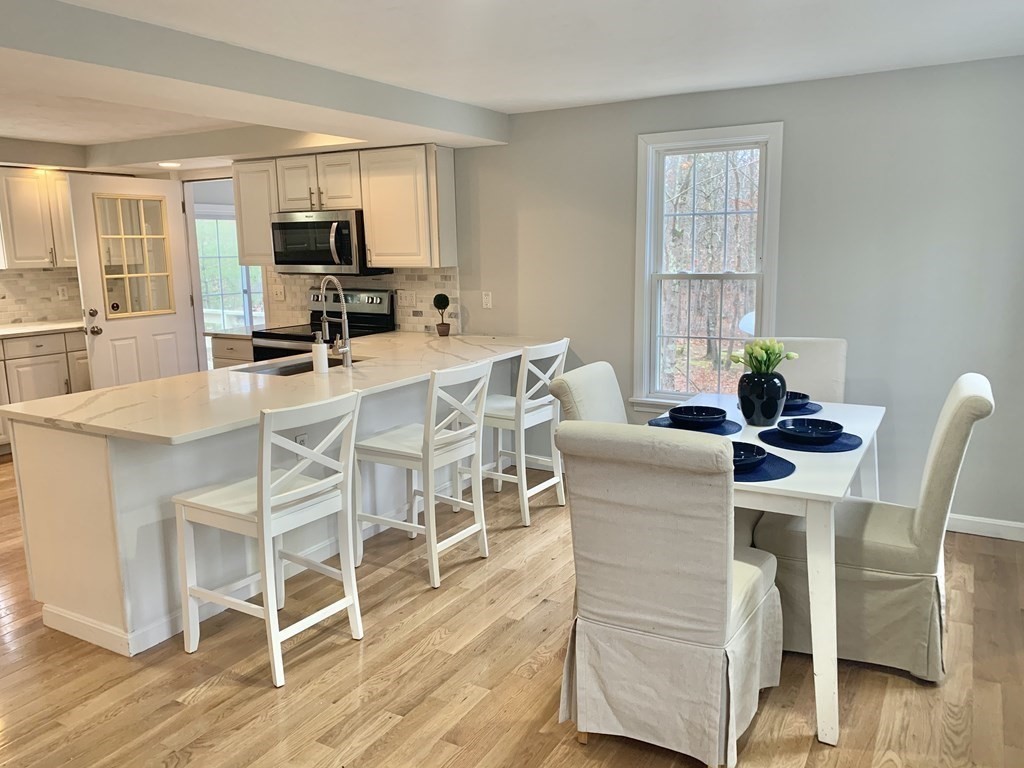 76 Old Douglas Road Webster, MA 01570 - Photo 5 of 22 a view of a dining room with furniture and wooden floor