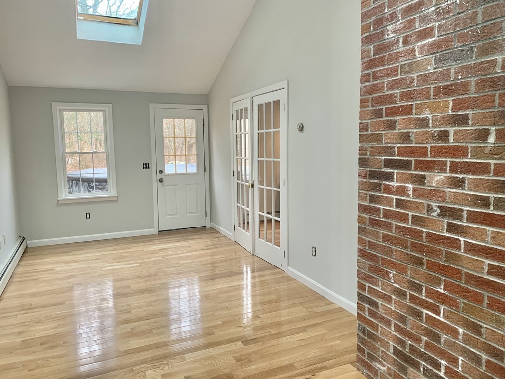 76 Old Douglas Road Webster, MA 01570 - Photo 10 of 22 a view of an empty room with wooden floor and a window