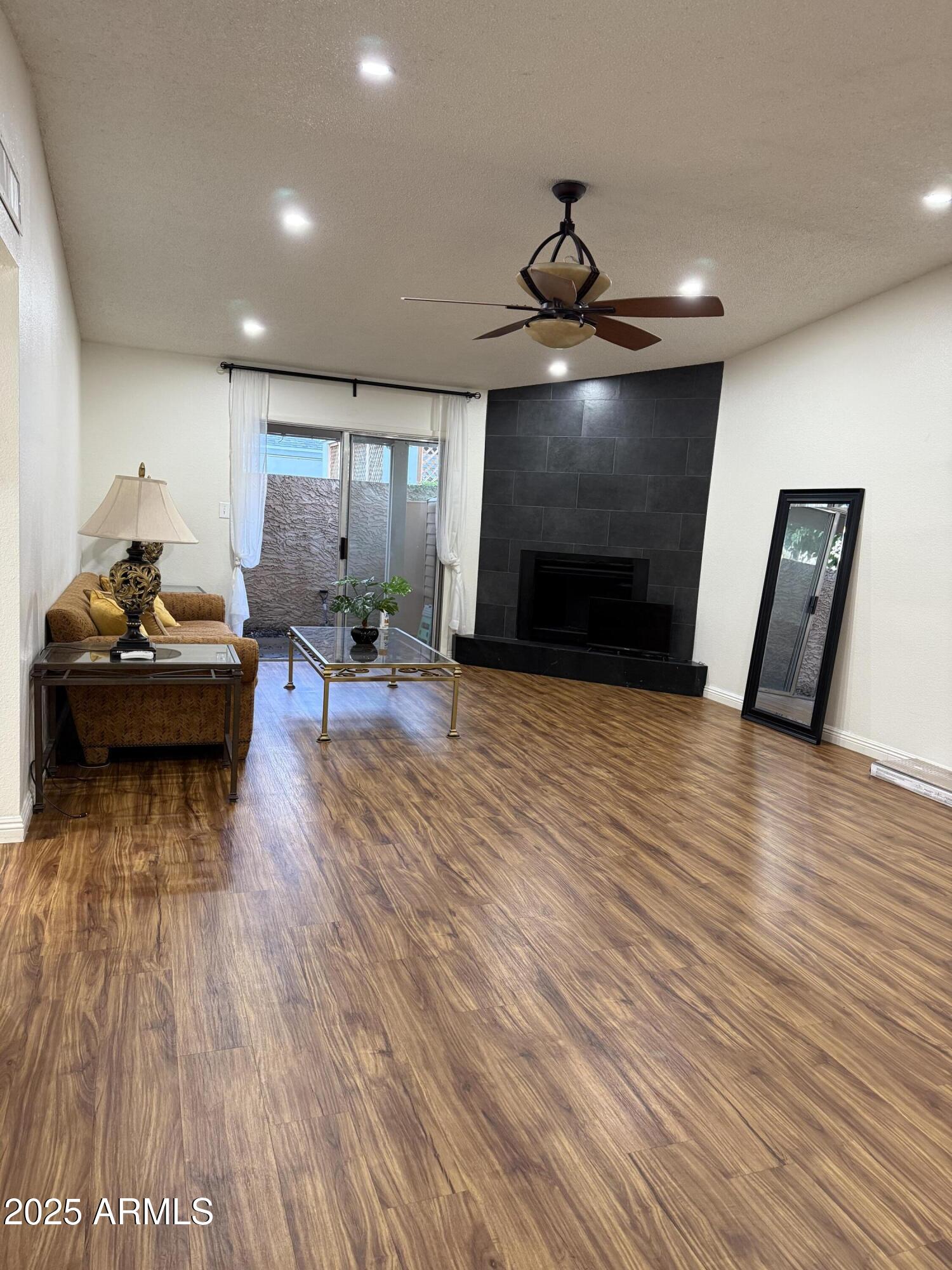 3033 North 37th Street, Unit 12 Phoenix, AZ 85018 - Photo 3 of 11 a living room with furniture and a wooden floor