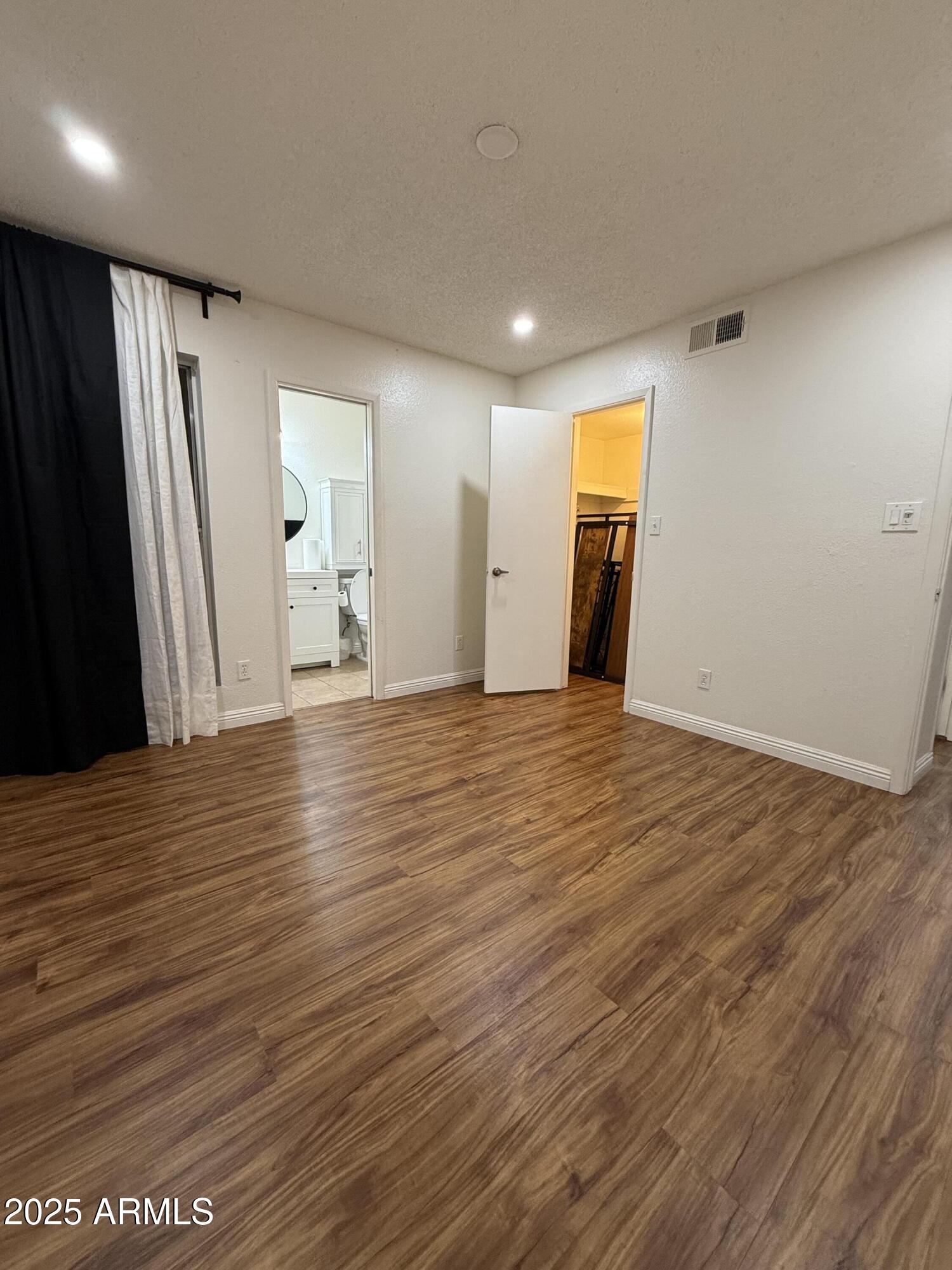 3033 North 37th Street, Unit 12 Phoenix, AZ 85018 - Photo 9 of 11 a view of a livingroom with wooden floor