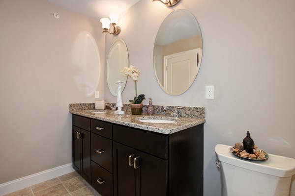 3 C Trail Ridge Way, Unit 7 Harvard, MA 01451 - Photo 25 of 30 a bathroom with a granite countertop sink a mirror and vanity