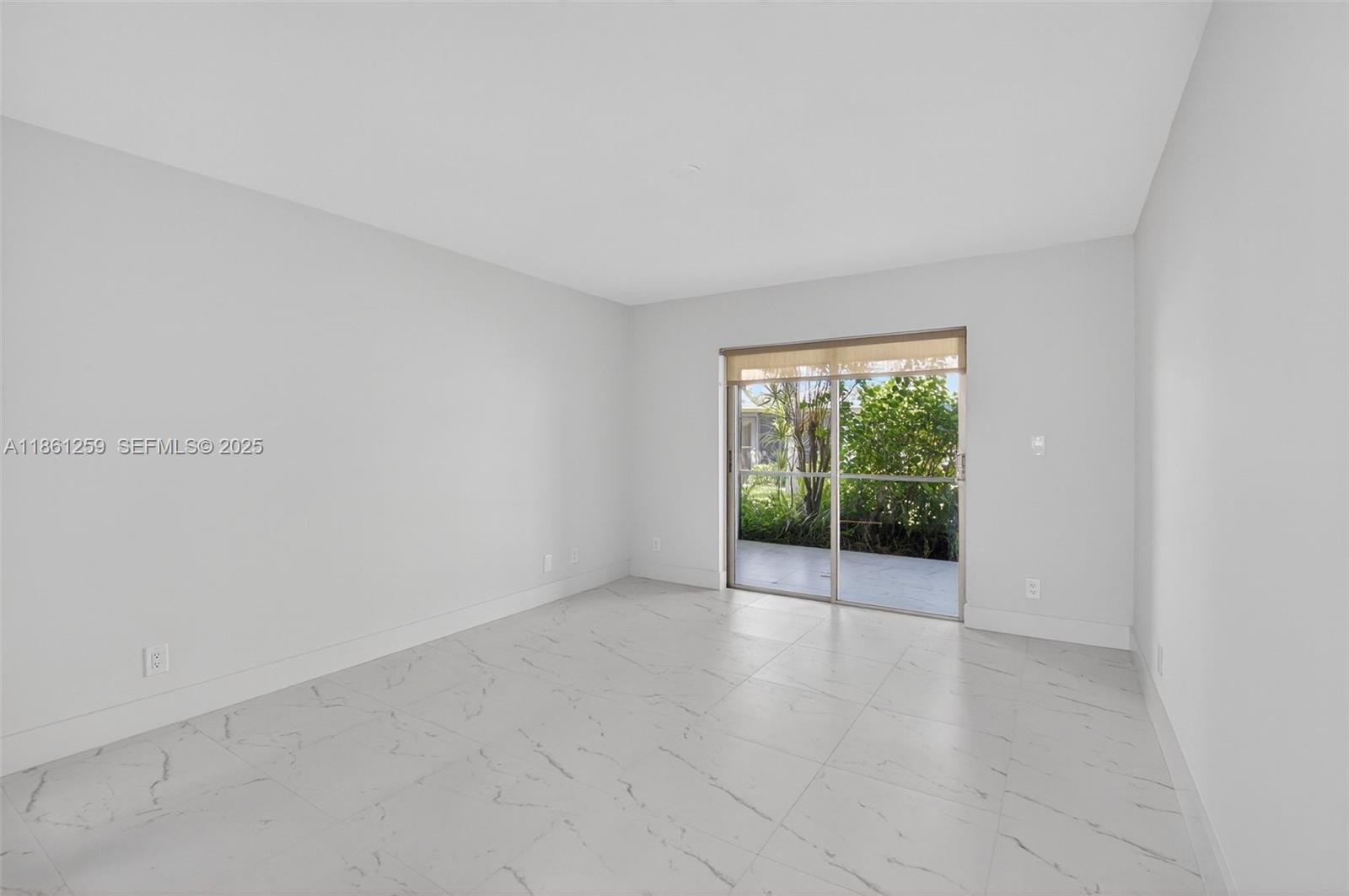 8840 Rheims Road Boca Raton, FL 33496 - Photo 16 of 41 an empty room with wooden floor and windows