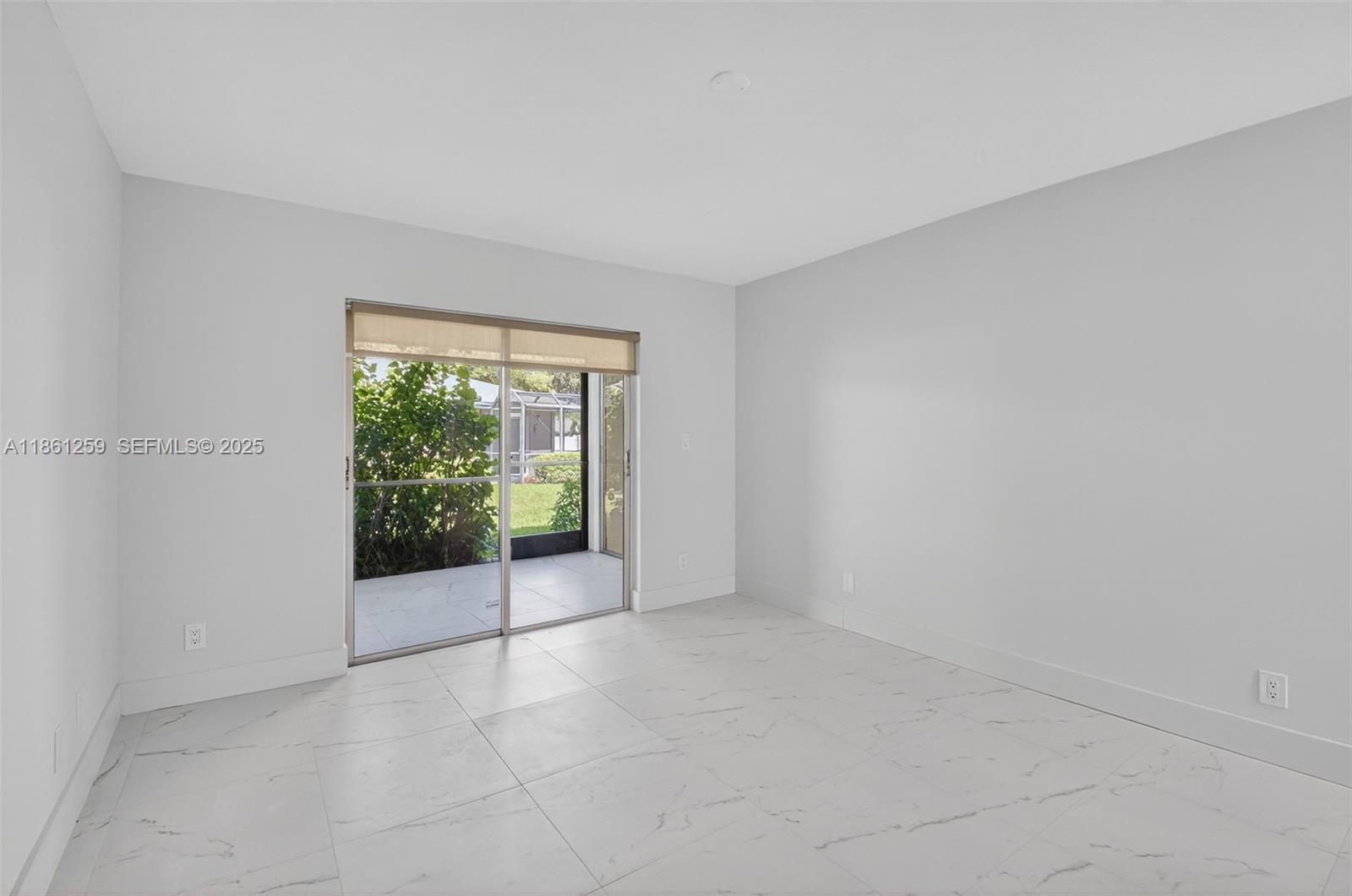 8840 Rheims Road Boca Raton, FL 33496 - Photo 17 of 41 a view of an empty room with glass door
