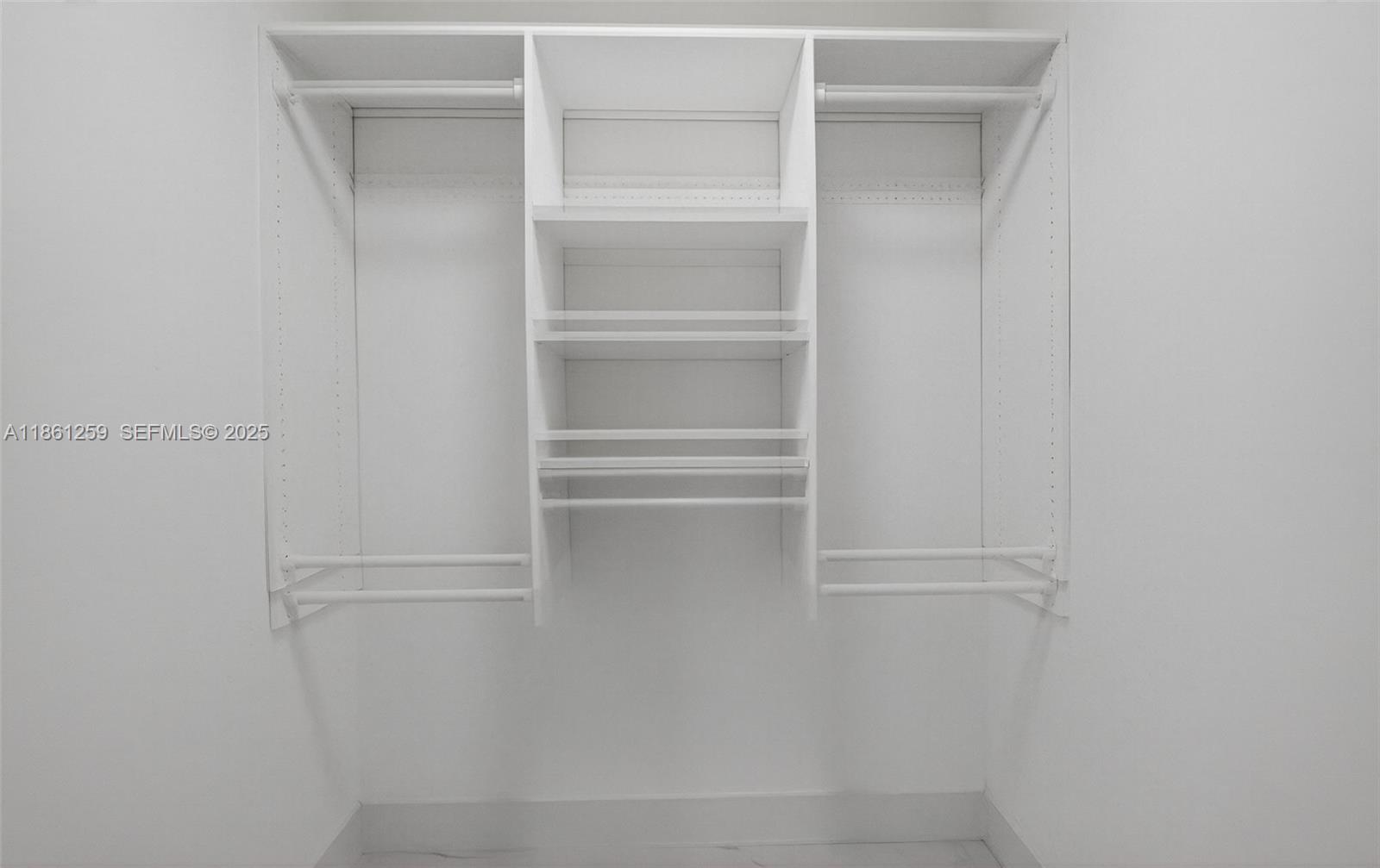 8840 Rheims Road Boca Raton, FL 33496 - Photo 19 of 41 a view of walk in closet with empty racks