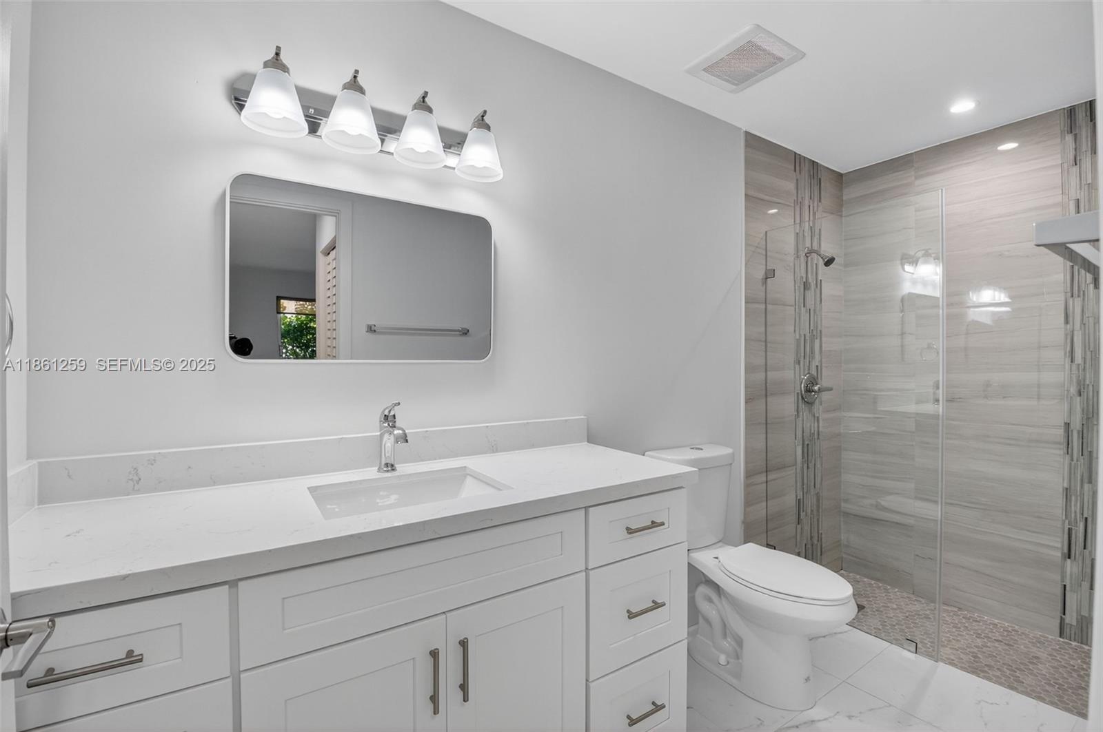 8840 Rheims Road Boca Raton, FL 33496 - Photo 20 of 41 a bathroom with a toilet sink and shower