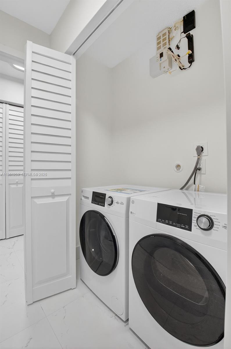 8840 Rheims Road Boca Raton, FL 33496 - Photo 22 of 41 a utility room with dryer and washer