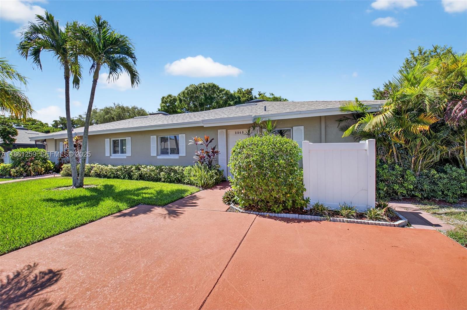 8840 Rheims Road Boca Raton, FL 33496 - Photo 3 of 41 front view of house with a yard and potted plants