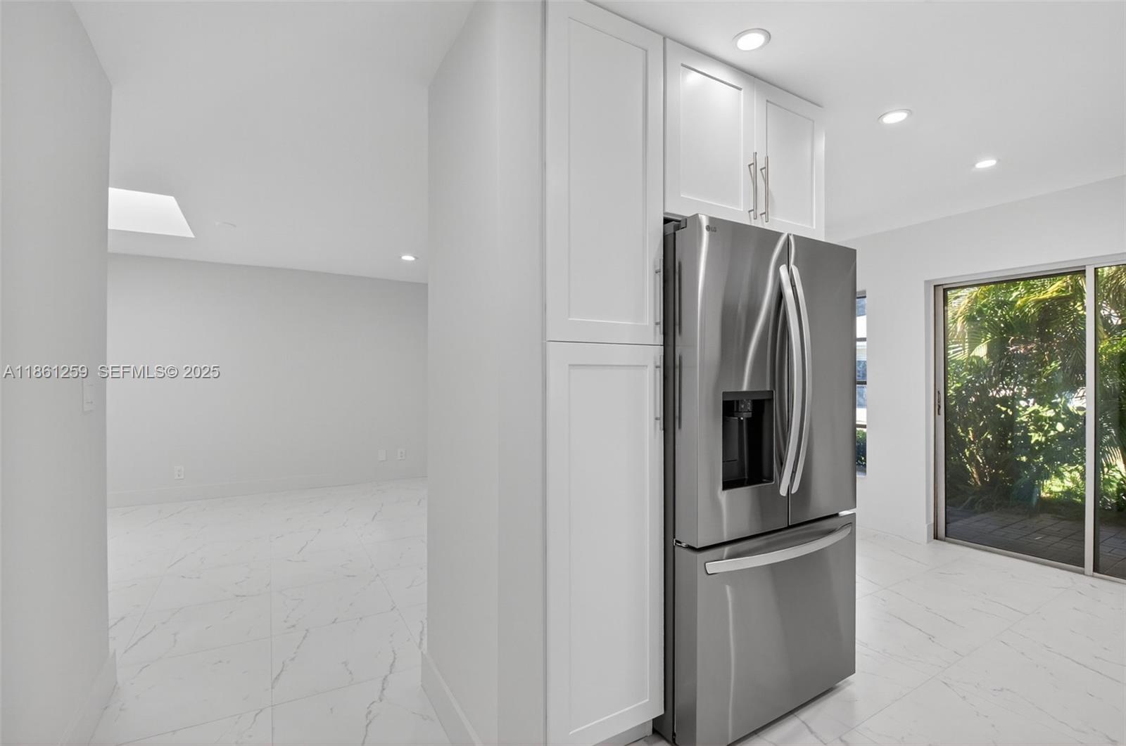 8840 Rheims Road Boca Raton, FL 33496 - Photo 6 of 41 a metallic refrigerator freezer sitting in a kitchen