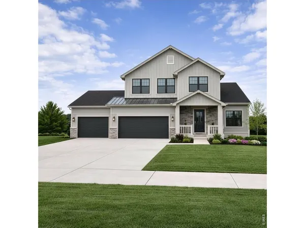 a front view of a house with a garden and yard