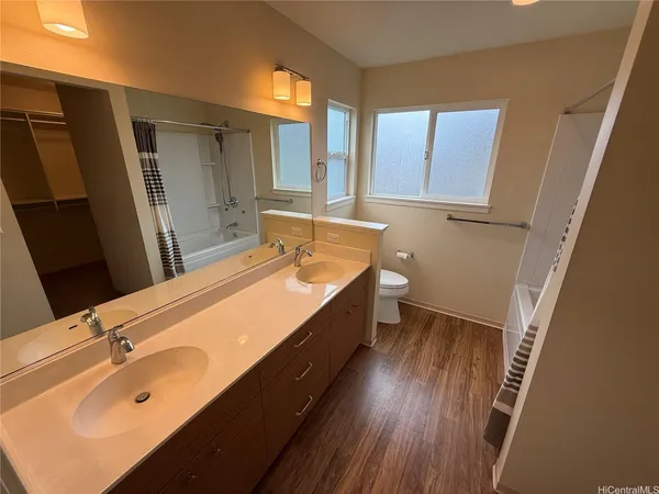 a spacious bathroom with a double vanity sink and a mirror