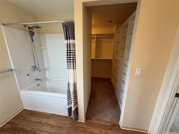 a bathroom with a bathtub a toilet and a shower