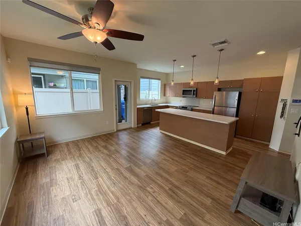 a view of kitchen with sink microwave and refrigerator