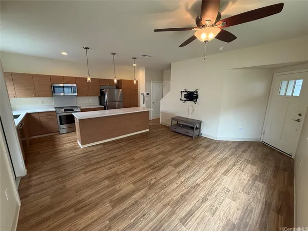 a living room with kitchen island furniture and a wooden floor