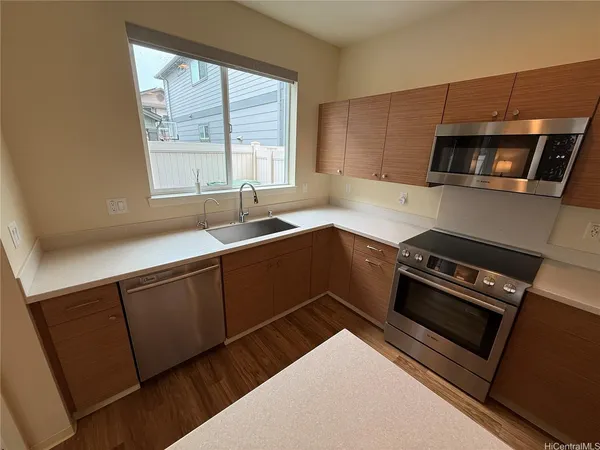 a kitchen with a sink a stove and cabinets