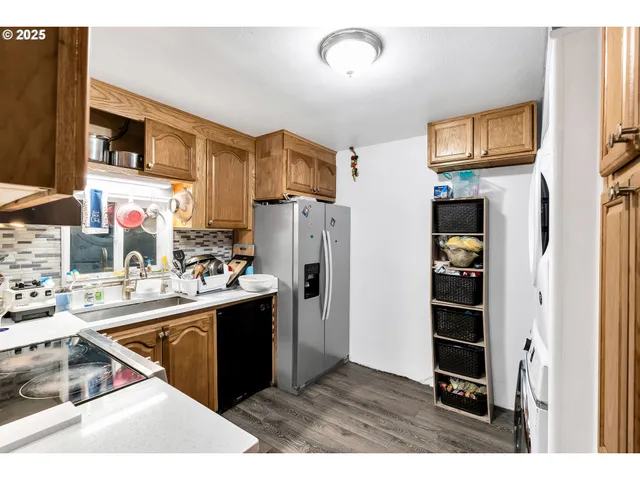 a kitchen with refrigerator and cabinets