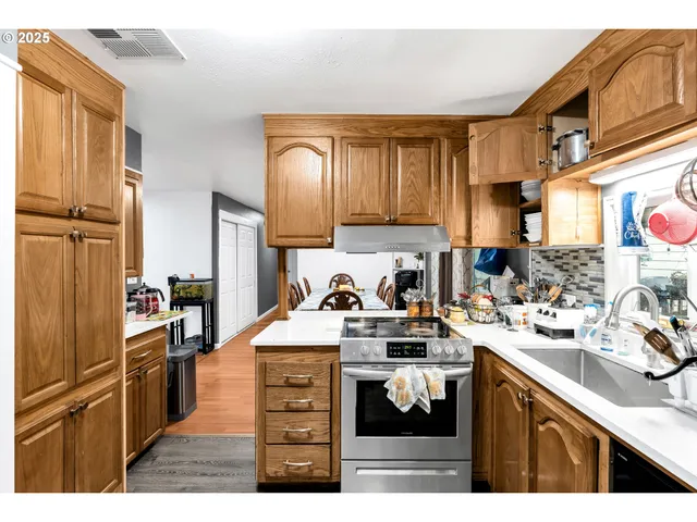 a kitchen with a sink stove and refrigerator