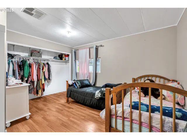 a bedroom with furniture and a closet